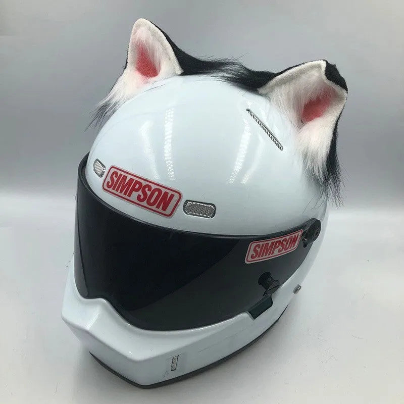 Set of black and white wolf ear and tail ornaments clipped to a motorcycle helmet