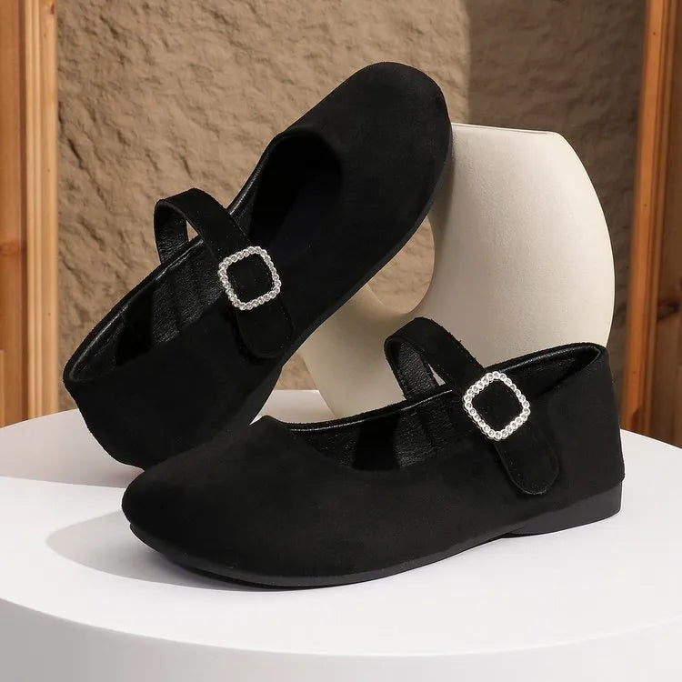 A pair of black men's canvas fisherman flat shoes with a rubber sole on a white background.