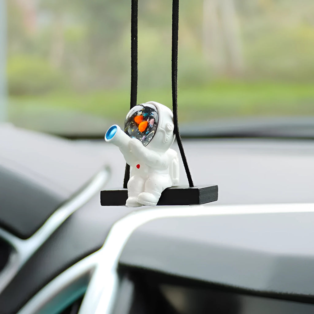 Cartoon style resin astronaut car pendant in five different colour and design variants.