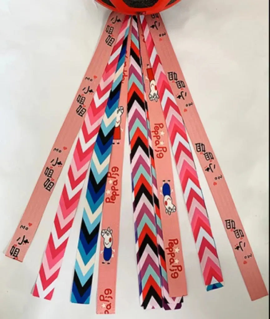 A decorative ribbon streamer for attaching to a child's roller skate or ski helmet, shown in a selection of colours.