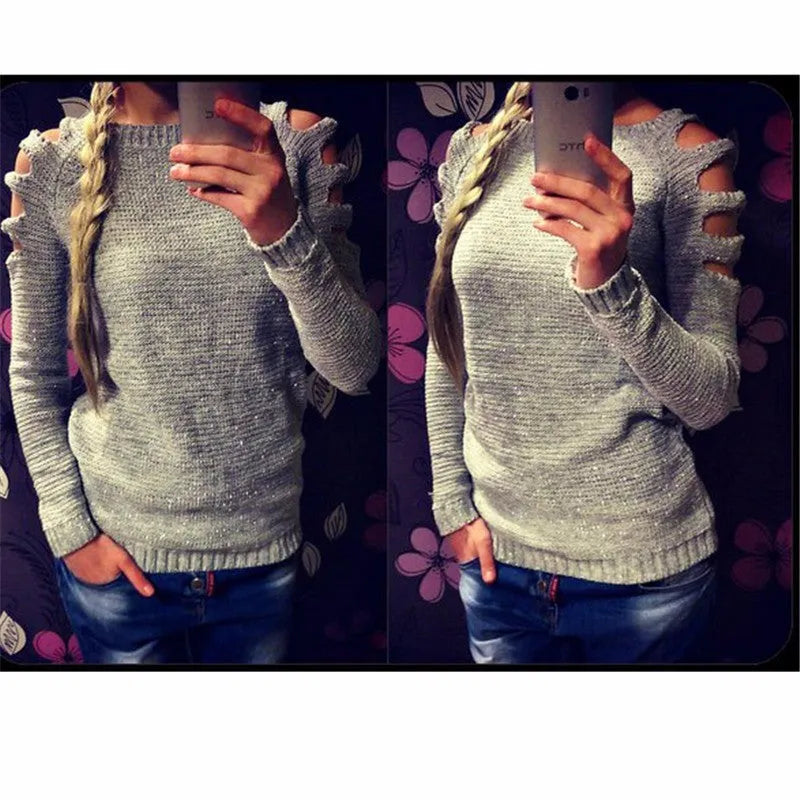 Women's grey hollow-out crochet long sleeve knit shirt on a hanger.