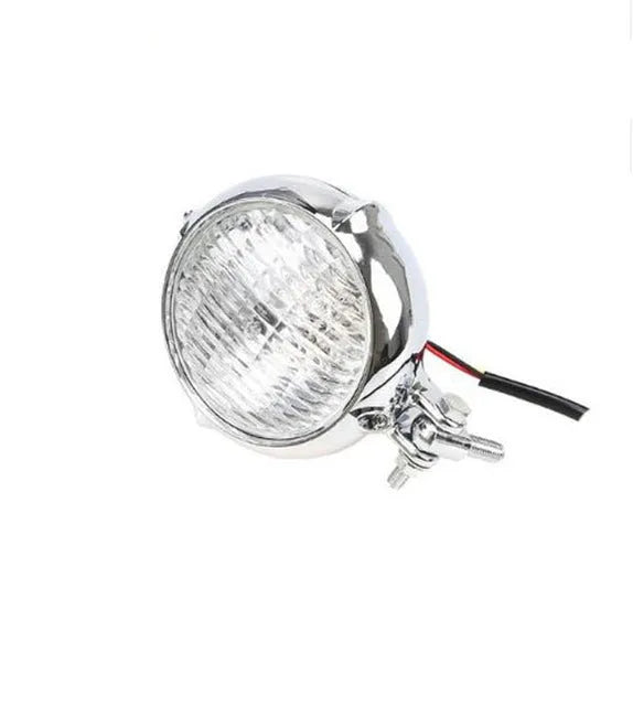 Black Harley-style halogen headlight unit with a large circular glass lens.