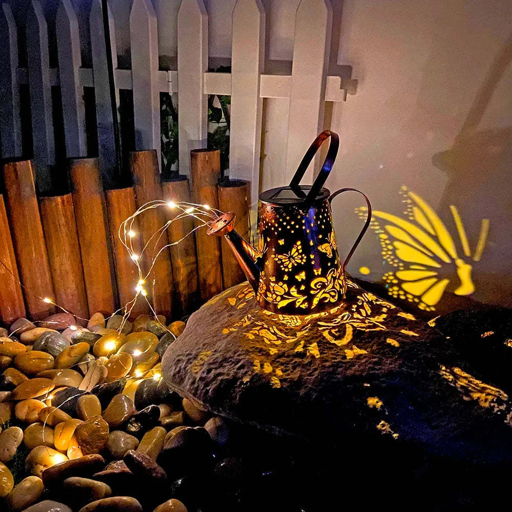 Solar-powered iron garden lamp with tapered butterfly design and warm white LED light.