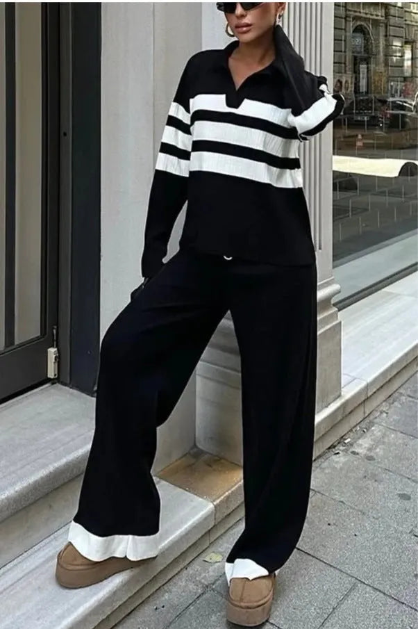 Women's black and white striped polo collar knitted top with matching trousers, a casual two-piece set.