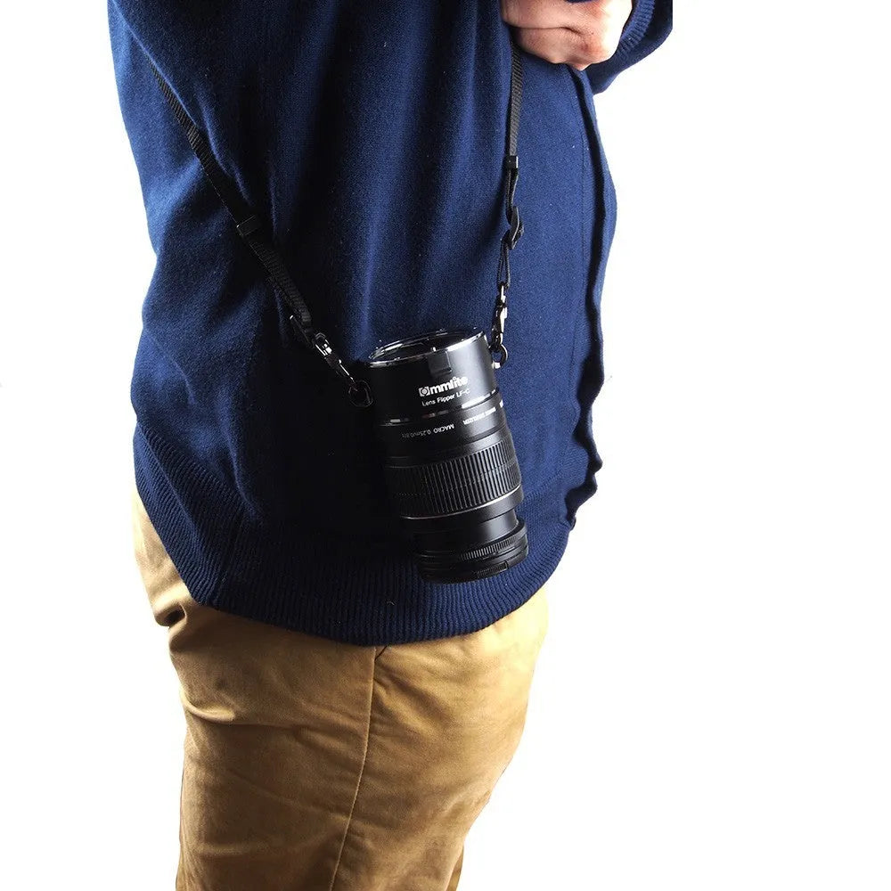 Aluminium camera lens flipper holder with cotton shoulder strap for quick lens changes on Nikon, Canon, or Sony cameras.
