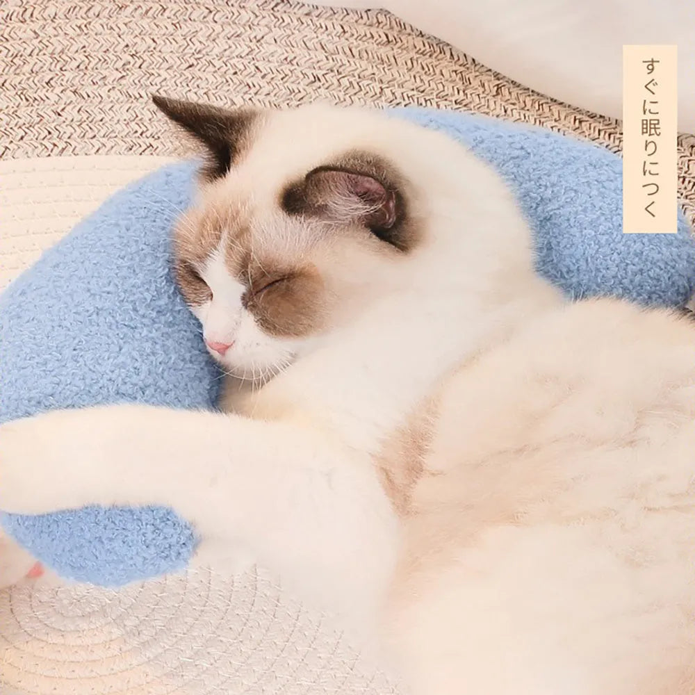 U-shaped blue cat pillow with adjustable collar placed on a sofa