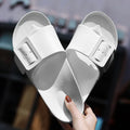 Women's grey blue EVA flip-flop sandals with a silver buckle on the strap, showing flat sole.