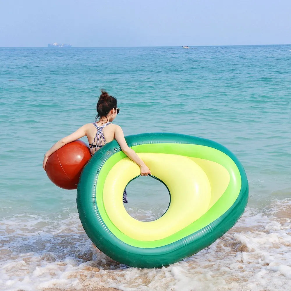 Green inflatable giant avocado pool float on water, showing its large 169x130cm size and smooth surface.