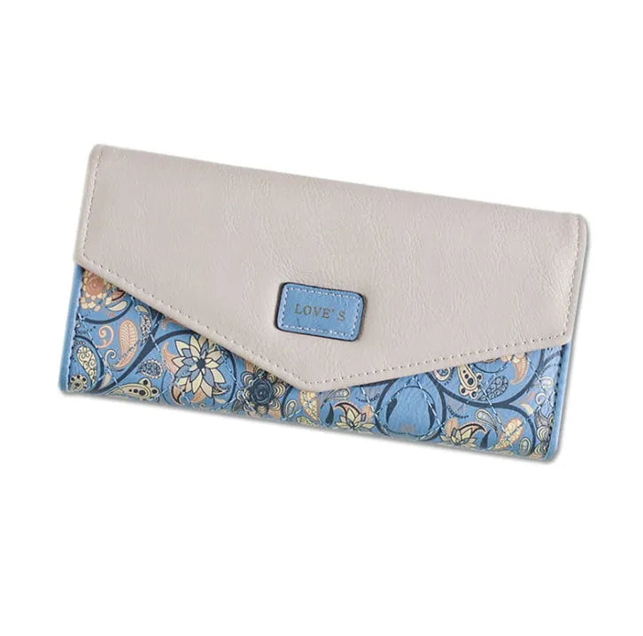 Women's large black trifold leather wallet with a buckle closure shown open and closed