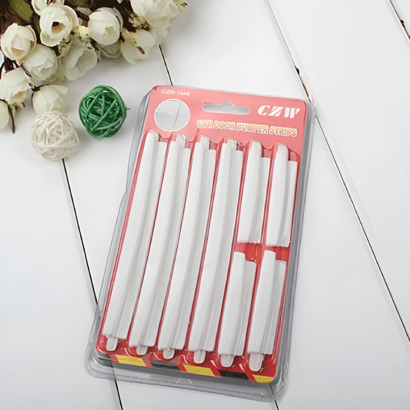 White self-adhesive PVC car door edge protector strip, 1000mm long, on a car door.