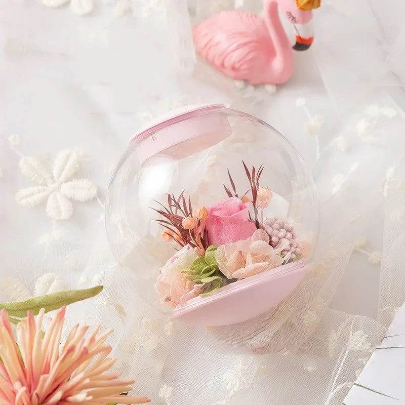 Pink preserved rose ornament in a decorative style, shown with optional base and bluetooth speaker features.