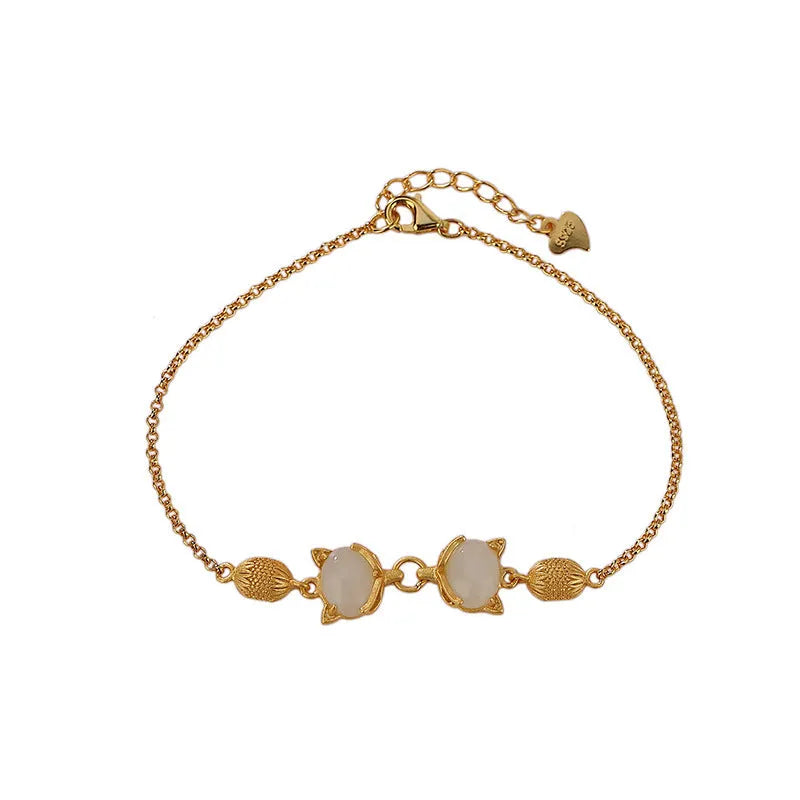 Close-up of a women's silver bracelet with a detailed retro fox charm on an adjustable chain.