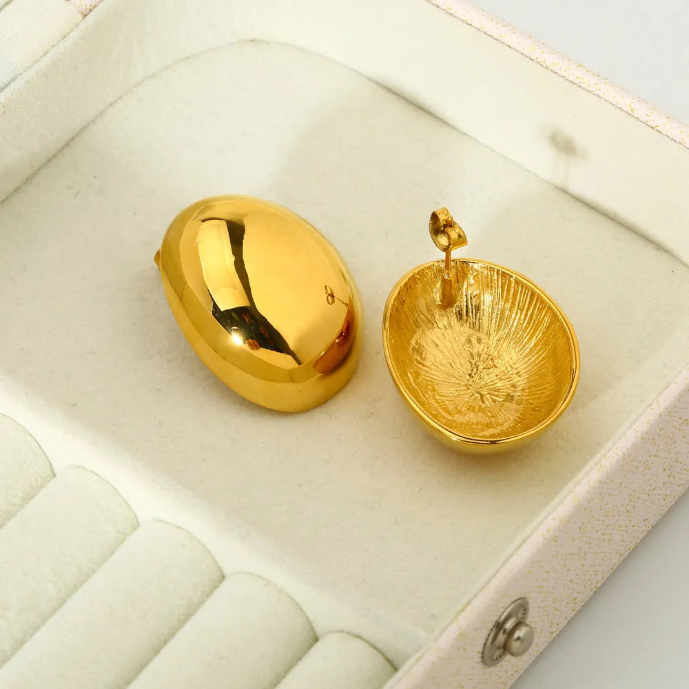 Geometric stainless steel ear studs with 18K gold plating and a glazed surface finish.
