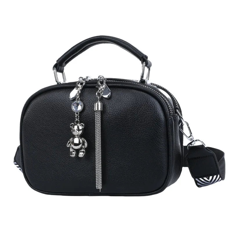 Oval-shaped women's small square handbag in PU with stitching detail and double straps.