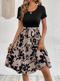 Women's khaki A-line dress with floral printing and a shoulder strap detail