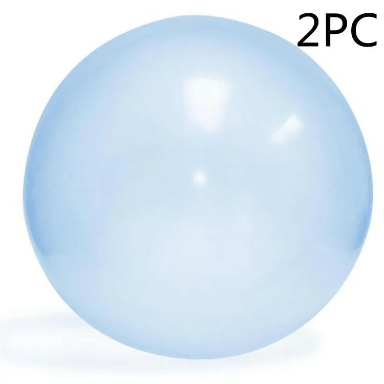 Assortment of inflated pink, yellow, blue and green TPR bouncy balls in different sizes on a plain background.