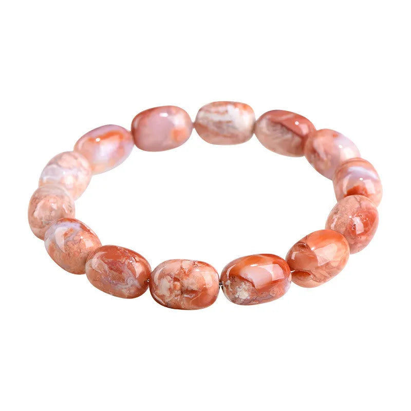 Natural cherry agate barrel bead bracelet with Ruyi charm on a wrist.