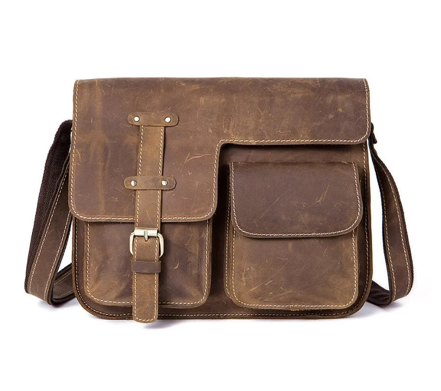 Brown full-grain leather vintage messenger bag with brass hardware, shown with strap adjusted