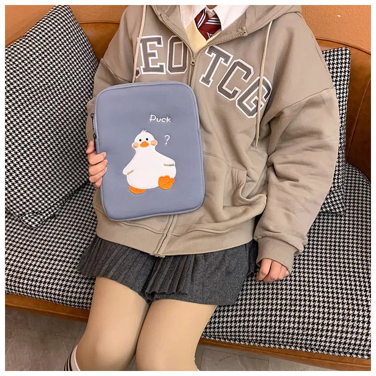 Blue cotton tablet case with embroidered cartoon duck design and a silver zipper.