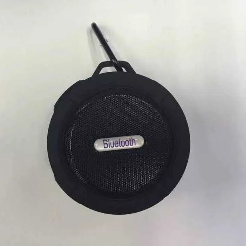 Compact waterproof Bluetooth speaker with a mounting clip, shown in blue.