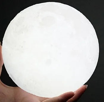 3D printed moon lamp on wooden stand showing detailed lunar surface, with touch ring at base.