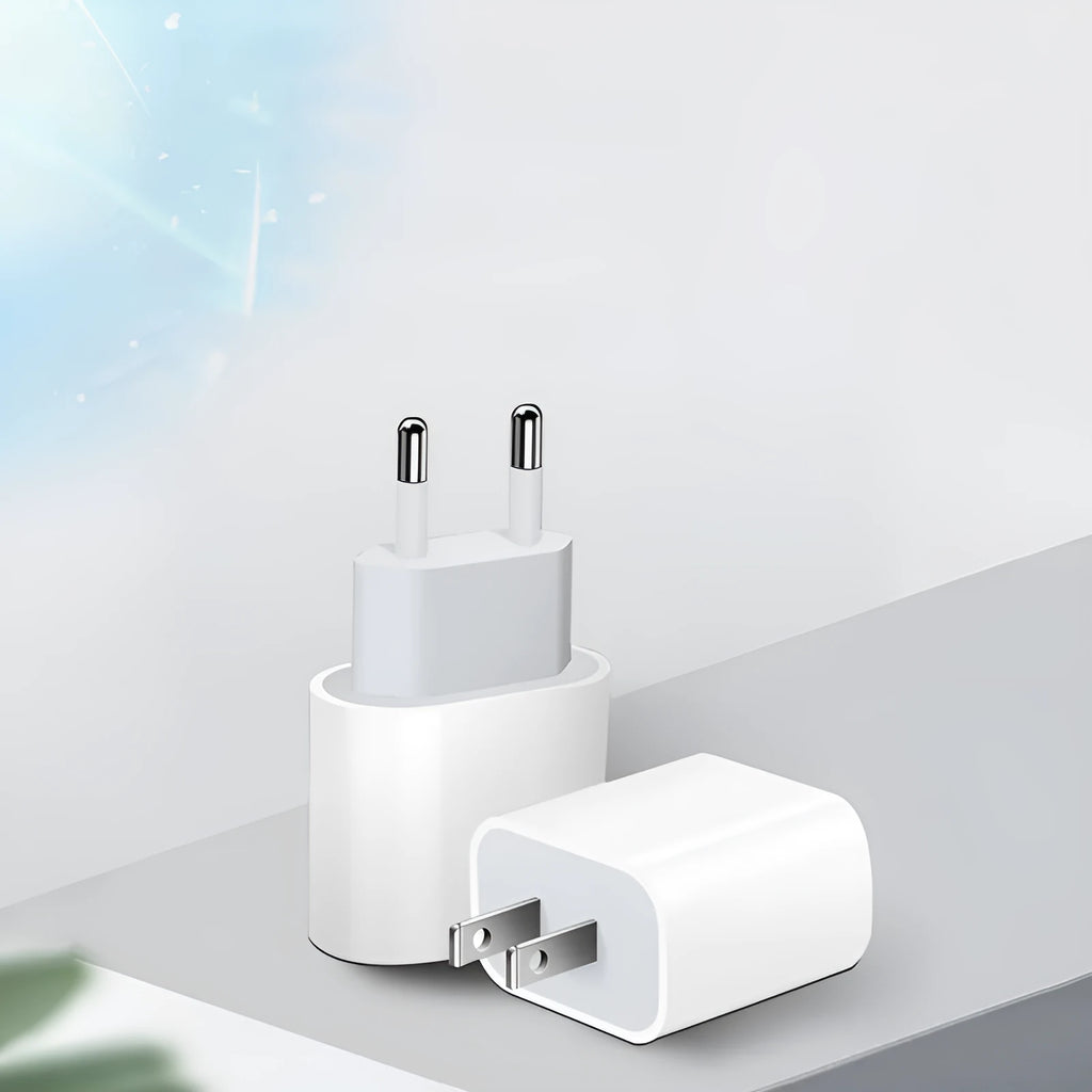White USB mobile phone charger with detachable European and American plug heads on a grey background