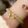 Bamboo-themed glass bracelet with coloured glaze beads and electroplated flower charm