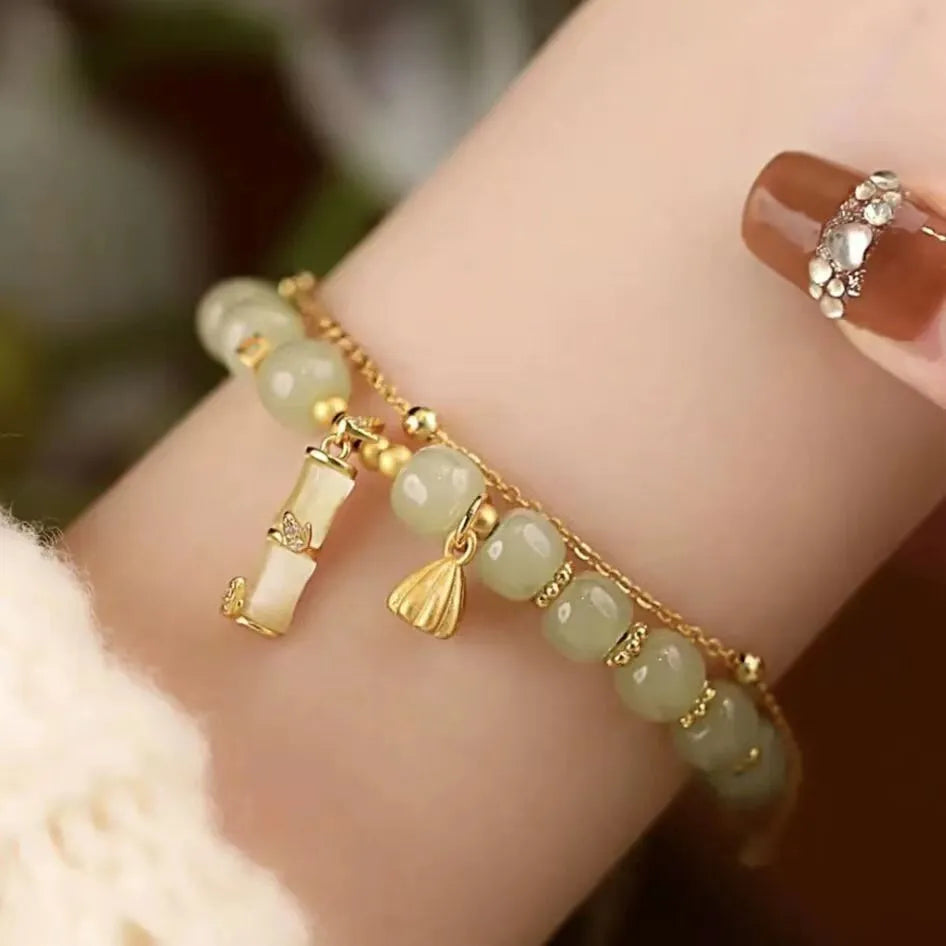 Bamboo-themed glass bracelet with coloured glaze beads and electroplated flower charm