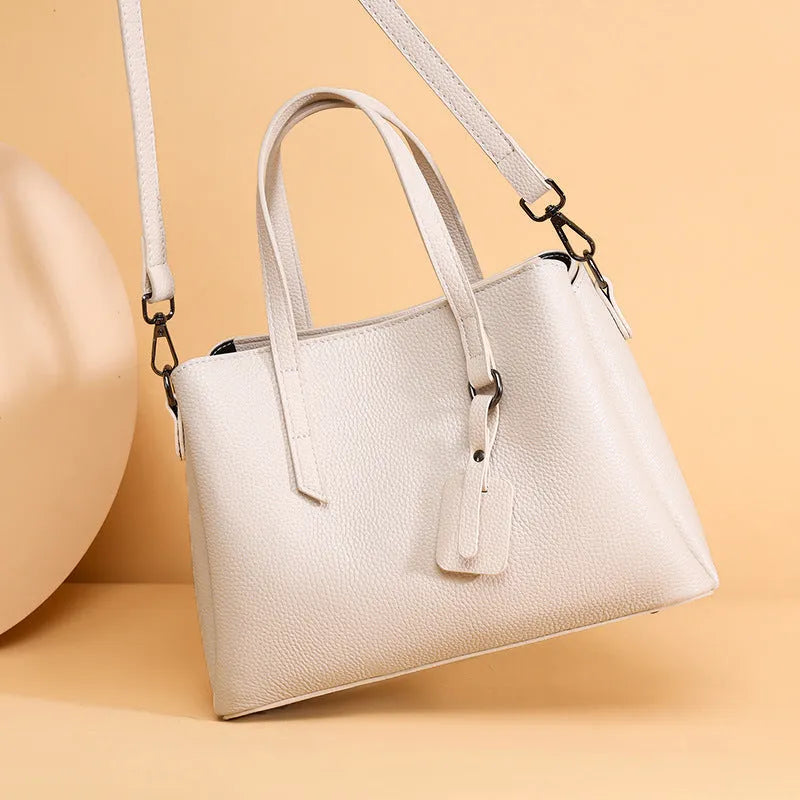 Women's cowhide leather large capacity handbag in horizontal square shape with single shoulder strap.