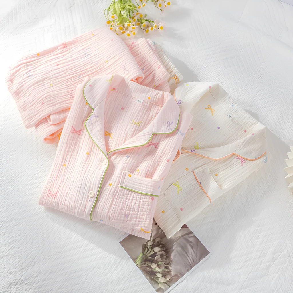 Women's long sleeve cotton pyjama set in pink, featuring a casual top and trousers.