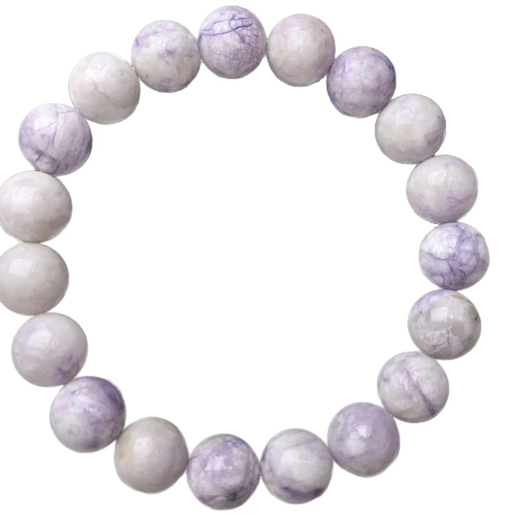 Close-up of a natural purple turquoise beaded bracelet with an adjustable string fastening.
