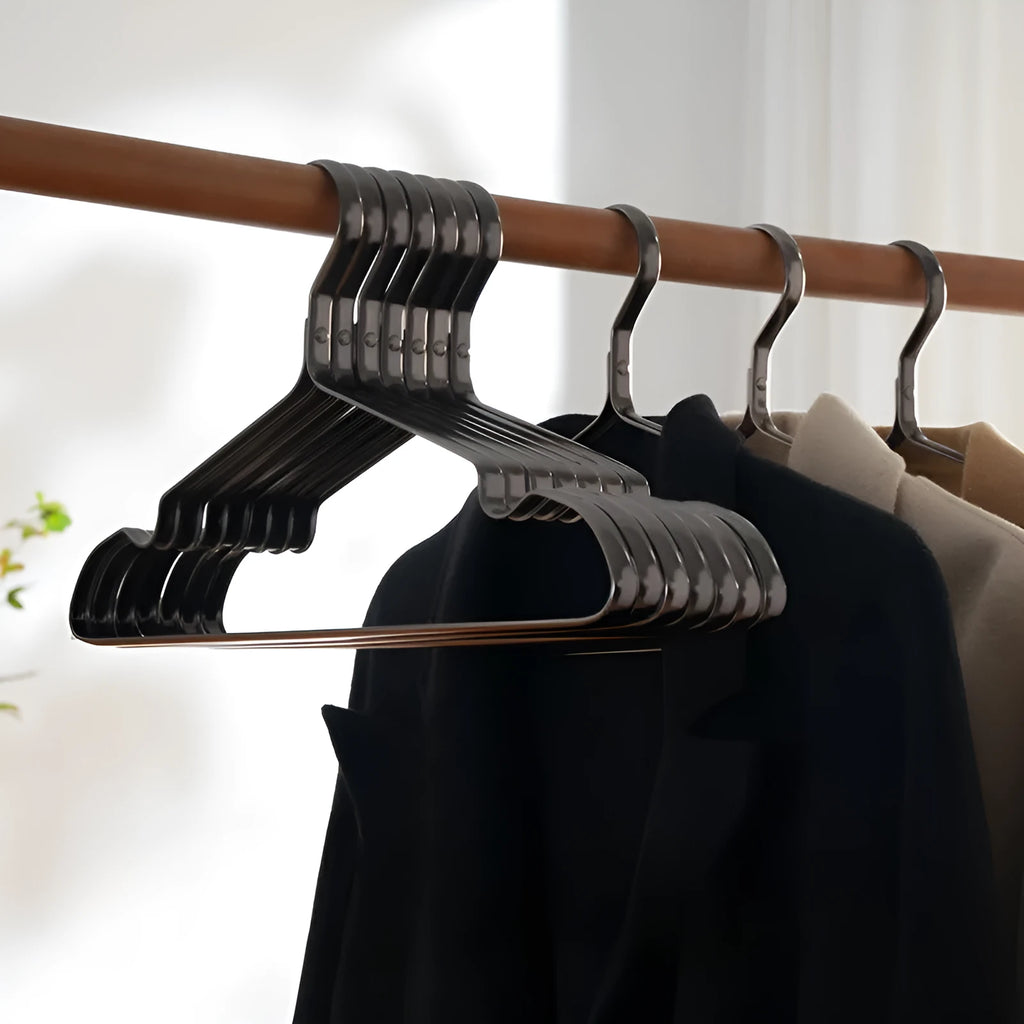 Elegant black non-slip clothes hanger for shirts, trousers and ties on a rail.