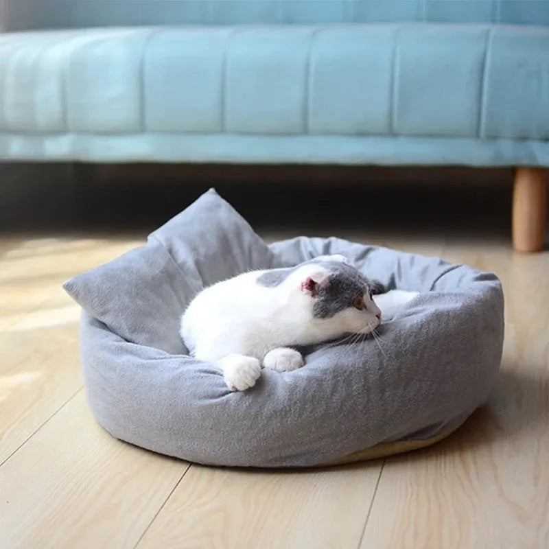 Grey round plush pet bed with a raised rim and non-slip base for small dogs and cats.