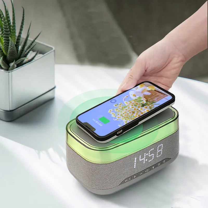 White multifunctional alarm clock with Bluetooth speaker, wireless charging pad, and night light.