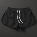 Men's loose beach shorts in orange, fluorescent green and black colours with elastic waistband