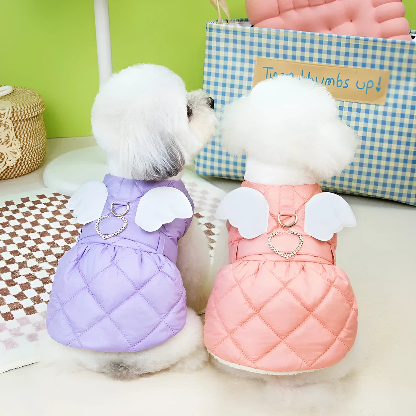 Small dog wearing pink cotton-thickened polyester skirt with cute angel design