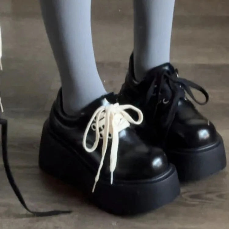 Matte black women's lace-up heels with a thick sole and round toe.