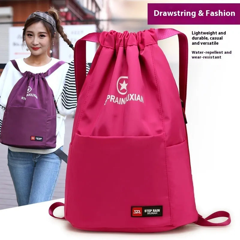 Lightweight solid colour Oxford cloth backpack with drawstring closure and double shoulder straps.