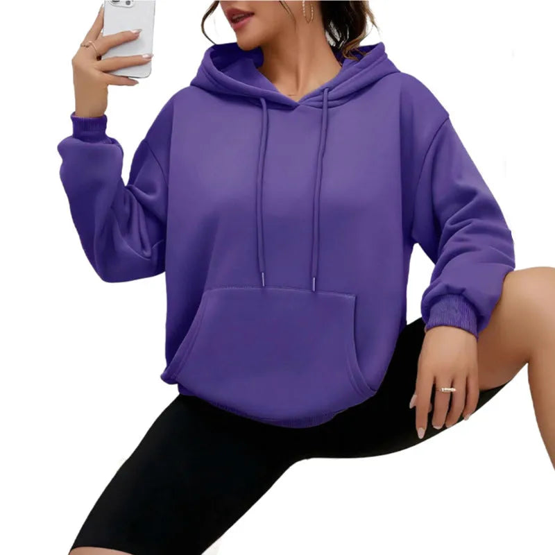 Women's loose grey drawstring hoodie with front kangaroo pockets, on a hanger.