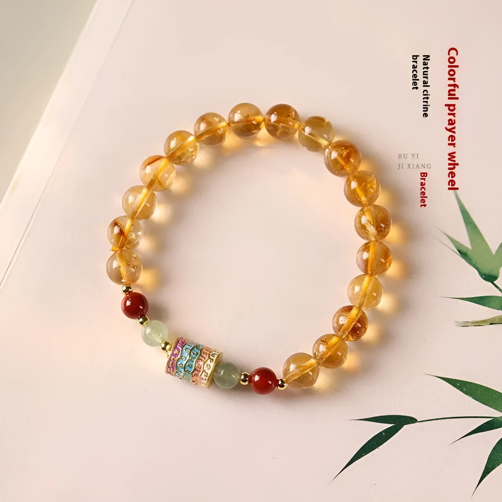 Yellow citrine bracelet with colourful prayer wheel beads on an 8mm round bead strand.