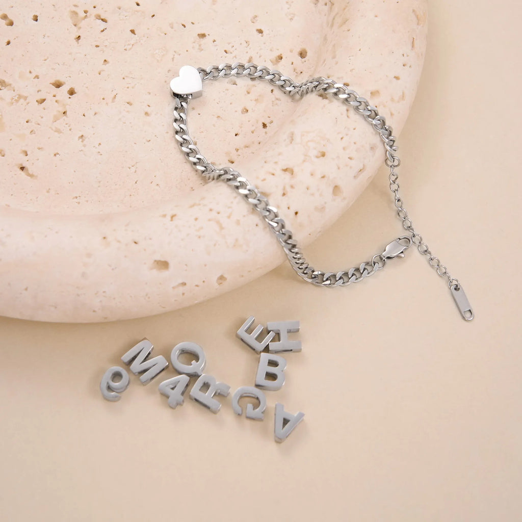 Gold and silver titanium steel necklaces with letter, number, and heart charms on a 40.5cm chain.