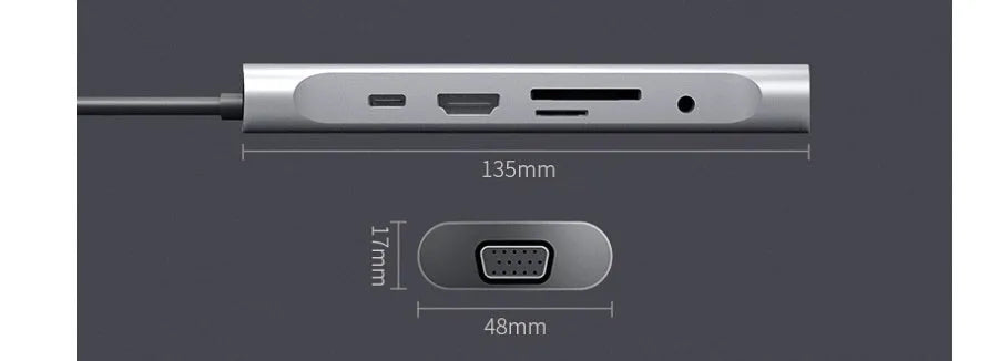 Grey aluminium USB-C docking station with HDMI, VGA, USB 3.0, and PD charging ports on a desk.