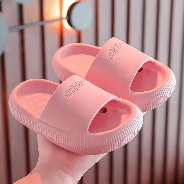 Children's mixed colour EVA slippers with textured non-slip soles and 1.5cm thick cushioning.