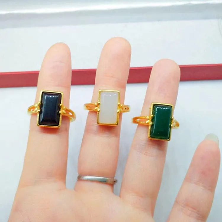Gold-plated brass ring with an adjustable band and a central green gemstone in a national style.