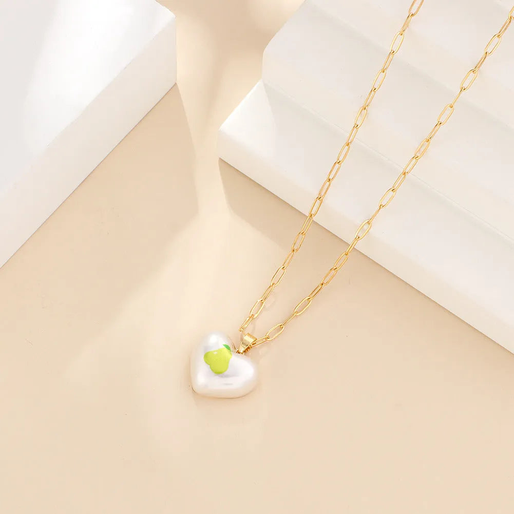 Geometric fruit pendant necklace with adjustable chain showing strawberry pineapple apple pear cherry designs
