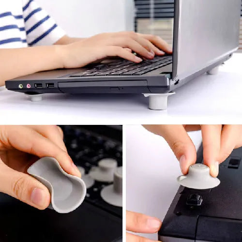 Four grey plastic laptop cooling pads, two large and two small, placed under a silver laptop on a wooden desk.