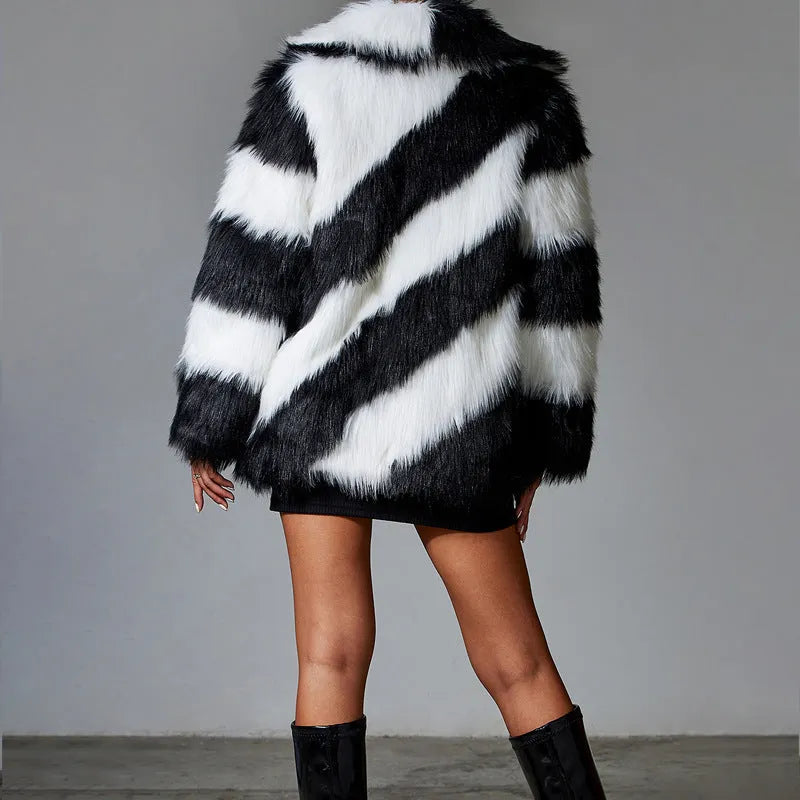 A picture colour faux fur coat with a contrast lapel and a textured fur collar, shown on a hanger.