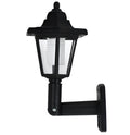 Black hexagonal solar wall light with solar panel for outdoor garden installation