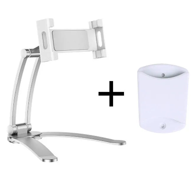 Silver aluminium alloy tablet stand with adjustable black clips holding a tablet, showing 360-degree rotation on a wooden desk.