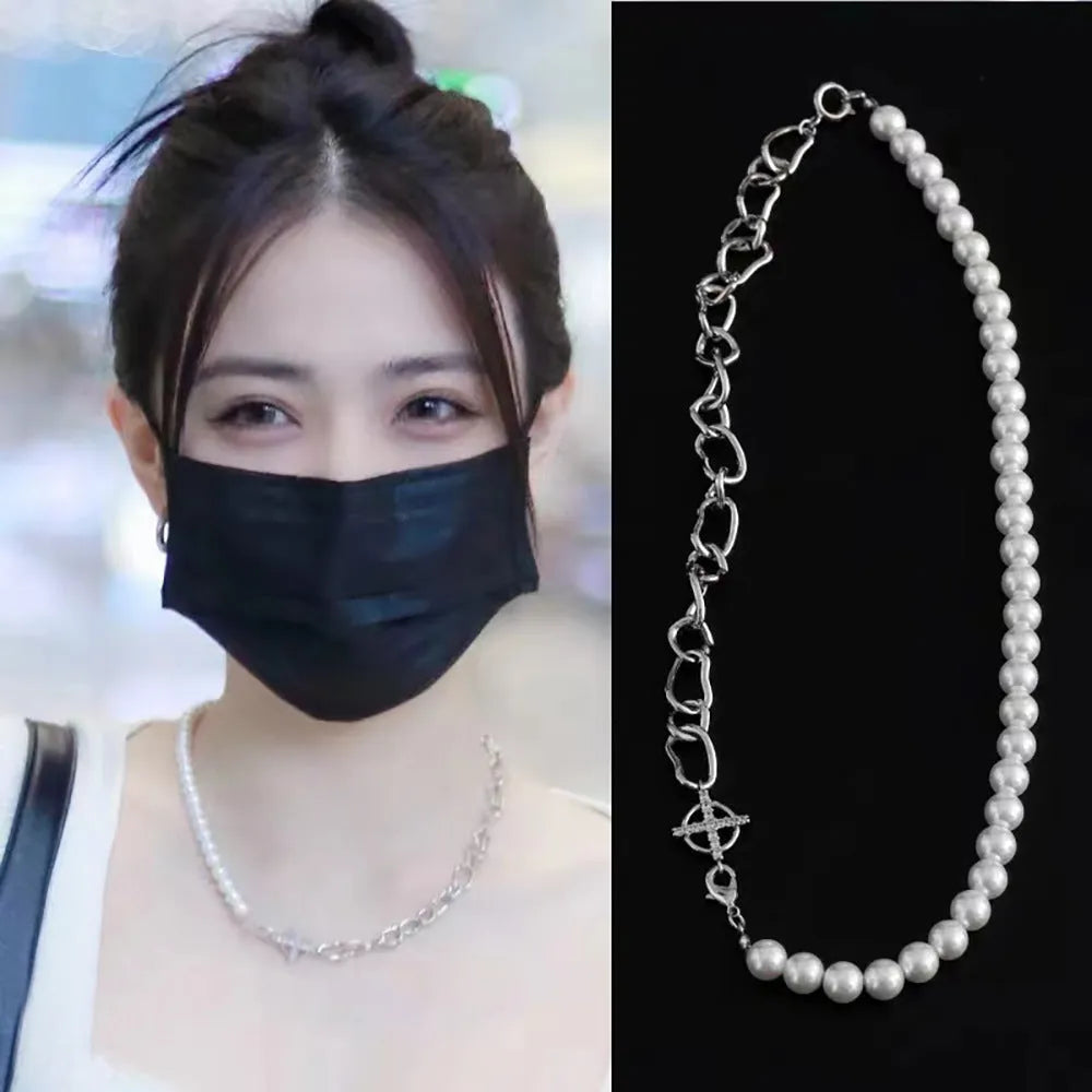 White geometric asymmetric acrylic pendant necklace on a twisted metal chain, shown against a neutral background.